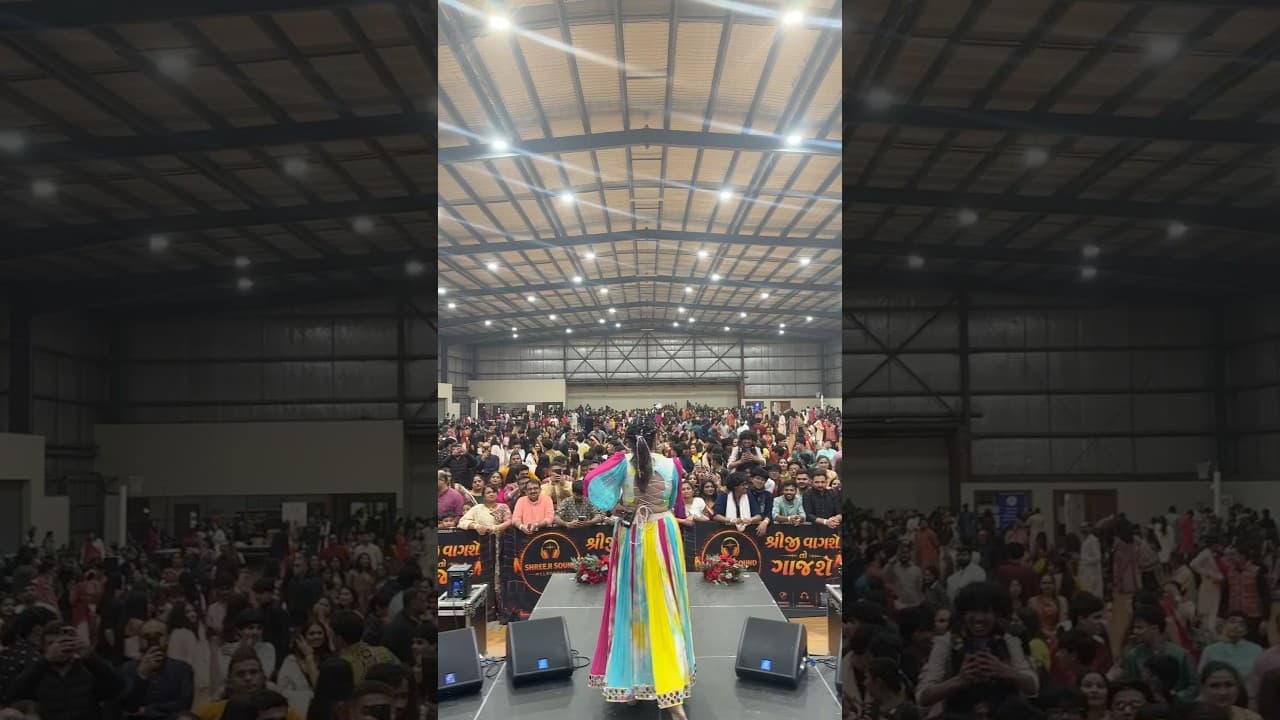 Kavya Limaye on stage facing a packed garba crowd in Melbourne
